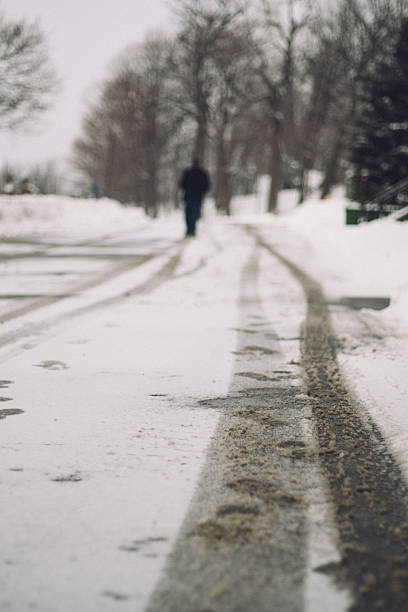 istock Lonely man walking through a snowy forest 505508488