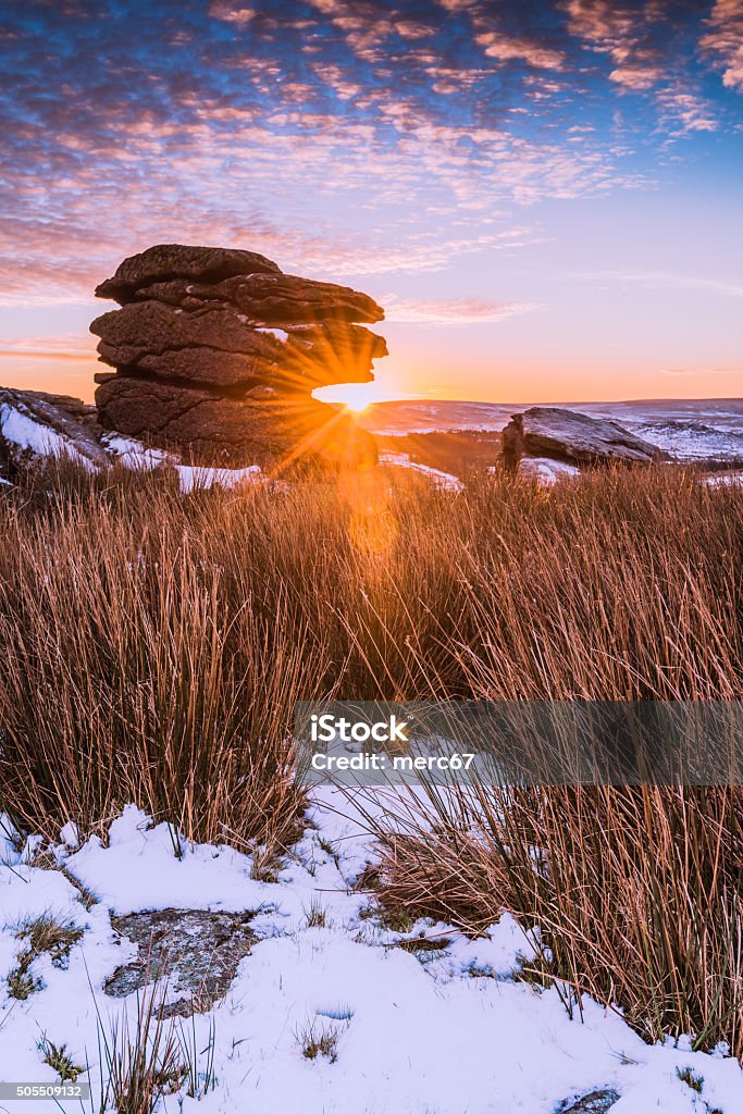 Spectacular sunrise on rocky hill mountain at snowy morning Spectacular sunrise on rocky hill mountain at snowy morning in Dartmoor National Park, Devon,UK. Dartmoor Stock Photo