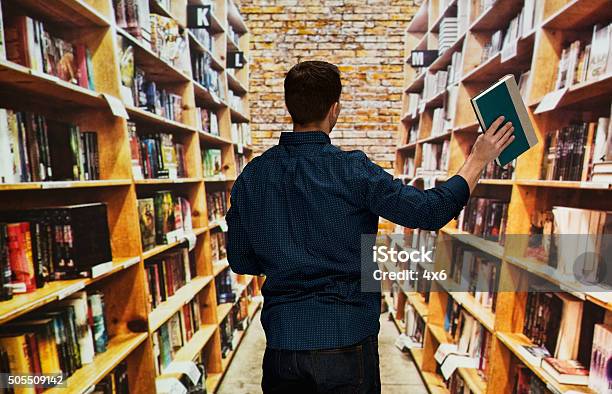 Male Librarian Working In Library Stock Photo - Download Image Now - Rear View, Bookshelf, 30-34 Years