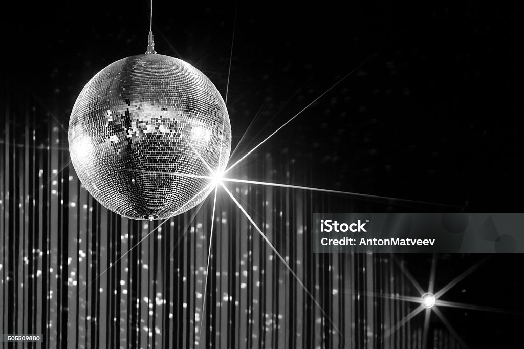 Party disco ball Party disco ball with stars in nightclub with striped walls lit by spotlight, nightlife entertainment industry, monochrome  Evening Ball Stock Photo