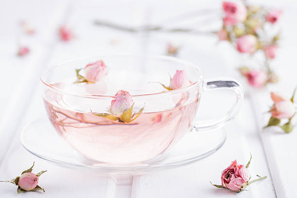 Tea with rose petals in a glass Cup Tea with rose petals in a glass Cup. Rose water. pink tea stock pictures, royalty-free photos & images
