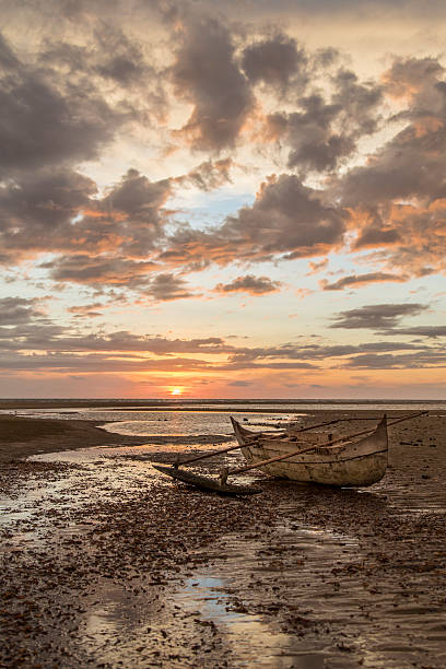 istock Old wooden sailor boat stranded on a sunset beach 505514086