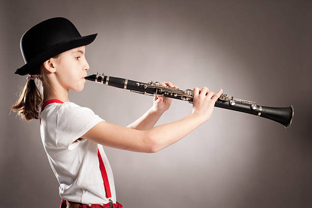 istock little girl playing clarinet 505516638