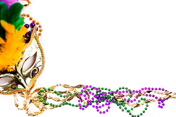 istock Mardi Gras background.  Purple, gold, green, mask, beads. 505517412