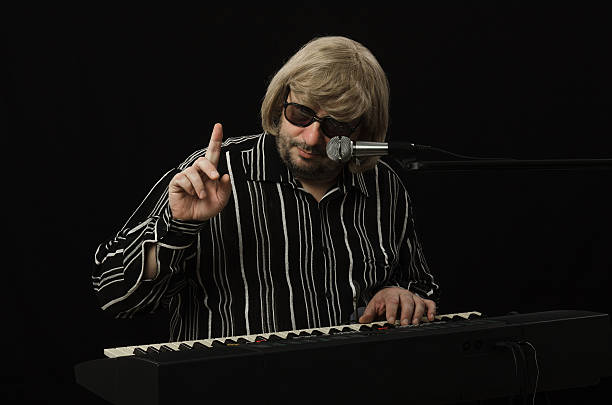 istock Mature musician gesturing attention sign 505517845