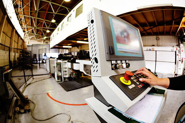istock Hand entering data on high-tech machinery at steel fabrication plant 505518367