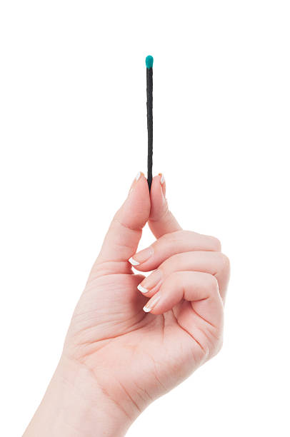 istock Female hand holding a match 505519519