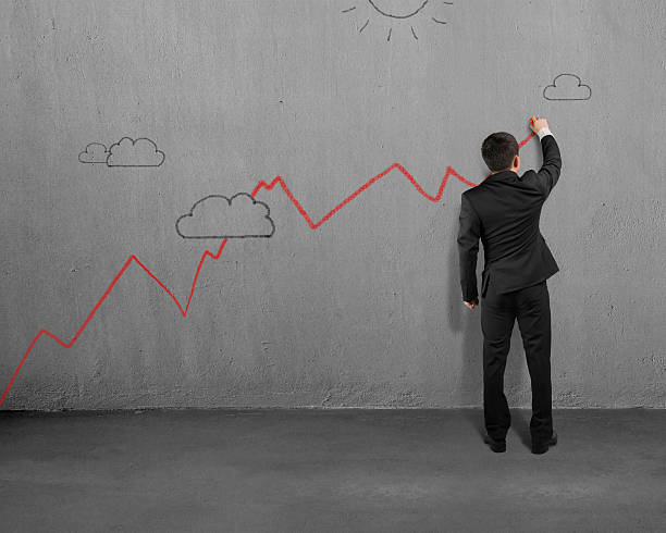 istock Man drawing red growing trend on wall 505519603