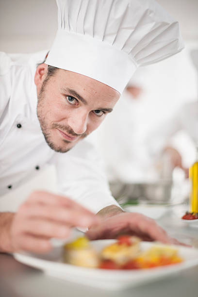 istock closeup on chef garnishing a plate 505519765