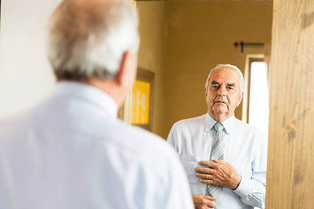 istock Grandfather looking himself at the mirror 505520068