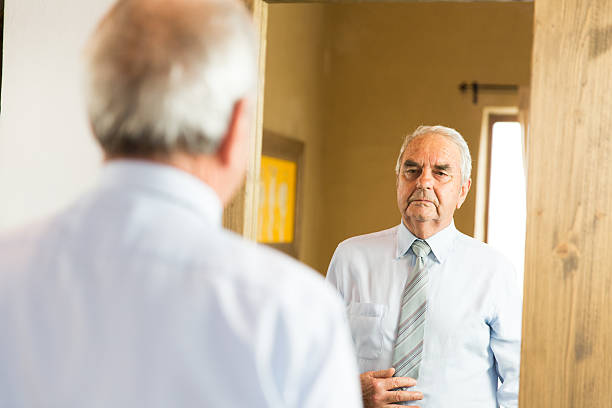 istock Grandfather looking himself at the mirror 505520292