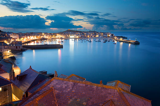 St Ives A twilight scene looking over St Ives. The photograph shows roof tops of the town and harbour in the background. A popular location for people visiting Cornwall. st ives cornwall stock pictures, royalty-free photos & images