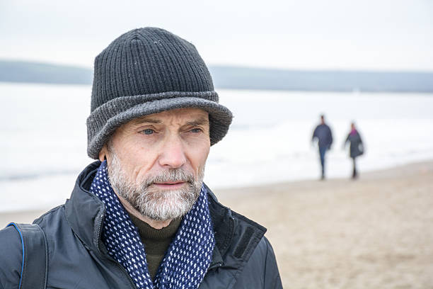 istock Gentleman in warm hat on the beach 505522114