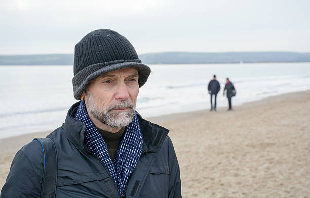 istock Retired man on beach in the winter 505522146
