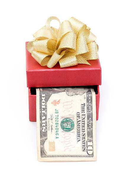 istock Red gift box with dollar bills on white background 505522271