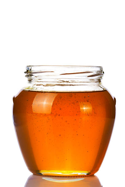 istock open full glass honey isolated on white 505523782