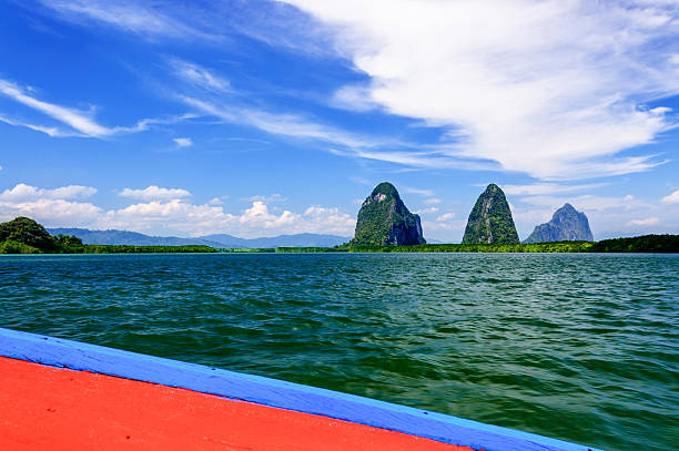 View of limestone karsts from boat View of limestone karsts from long-tail boat in Phang Nga Bay, Southern Thailand phang nga province stock pictures, royalty-free photos & images