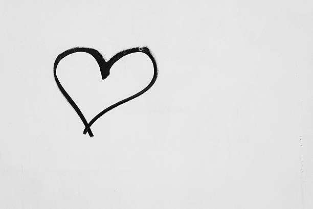 istock Heart shape sketched on a white wall in black ink 505524562