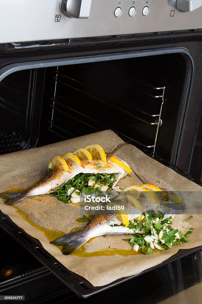 Cooked fish sea bream fish. Cooked fish sea bream fish with lemon, parsley,garlic. Animal Stock Photo