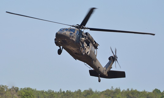 A UH-60 Blackhawk operated by the Army Rangers lands on a runway.