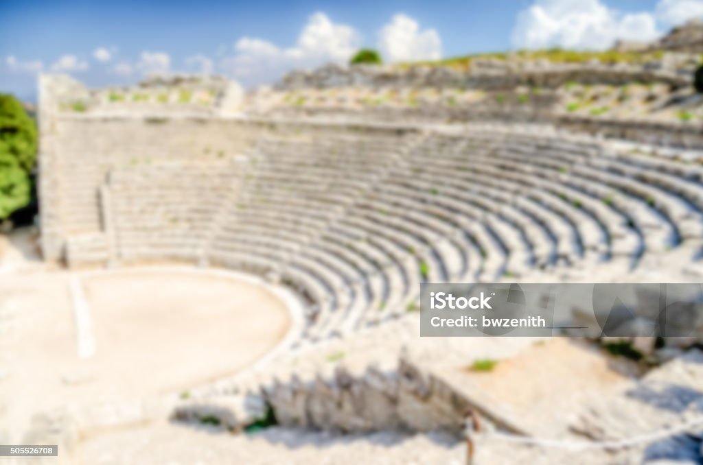 Defocused background with the Greek Theatre of Segesta, Italy Defocused background with the Greek Theatre of Segesta, Italy. Intentionally blurred post production for bokeh effect Amphitheater Stock Photo