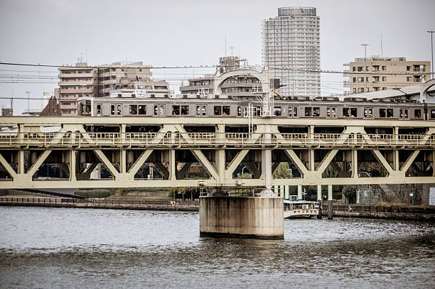 Tokyo, Japan - November 22, 2015: Train passing over bridge in Tokyo. Photo taken during the day.
