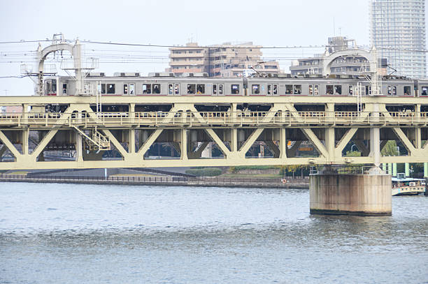Tokyo, Japan - November 22, 2015: Train passing over bridge in Tokyo. Photo taken during the day.
