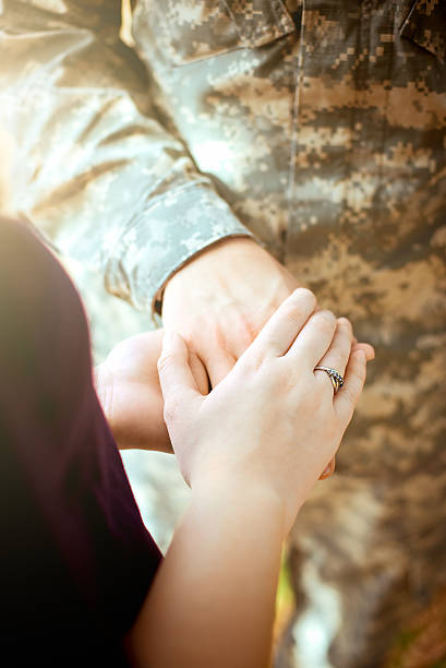 istock Married military couple holding hands 505529338