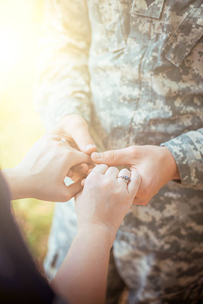istock Married military couple holding hands 505529354
