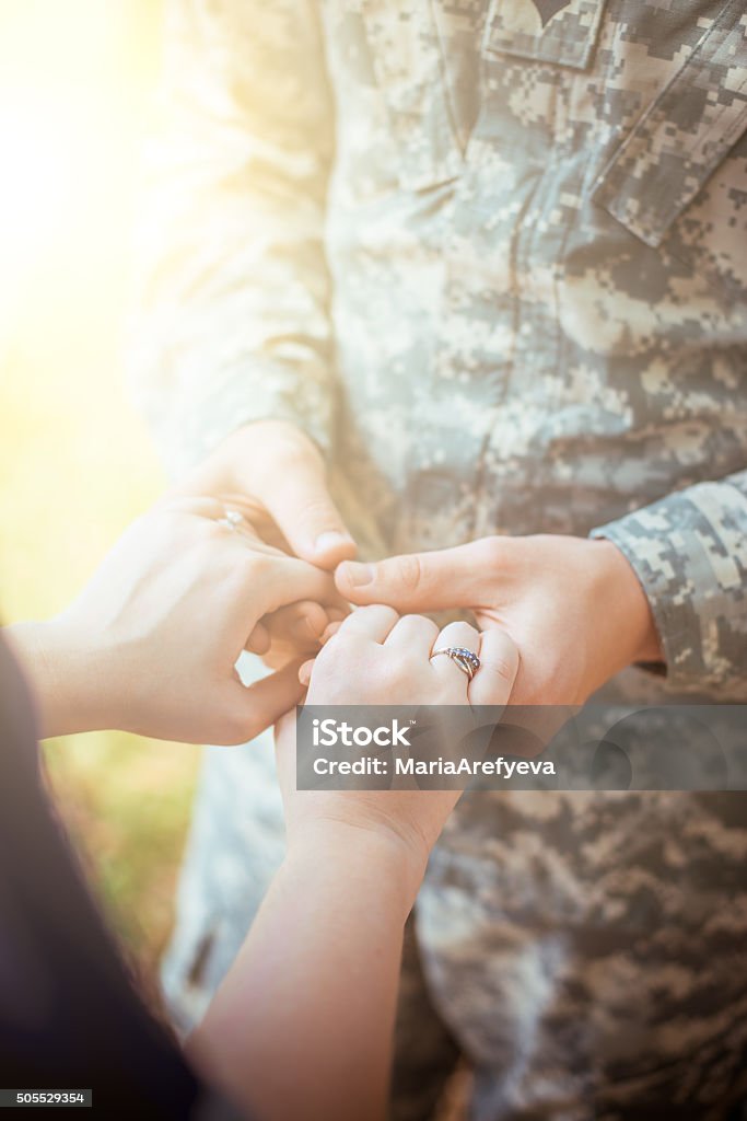 Married military couple holding hands Armed Forces Stock Photo