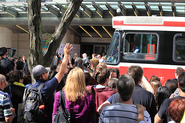Toronto International Film Festival Toronto, Сanada- September 8, 2013: Street car traveling in front of the Prince of Wale Theatre, with a crowd trying to see celebrities, at the Toronto International Film Festival.  toronto international film festival stock pictures, royalty-free photos & images
