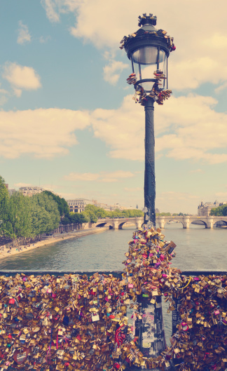 The romantically love inscribed padlocks on the Pont Des Arts Bridge, Paris France. with retro vintage Instagram style effect.