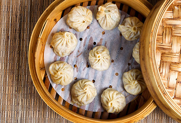 istock Freshly cooked dumplings inside of bamboo steamer ready to eat 505531588