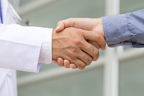 istock Doctor shakes hands with a patient 505533632