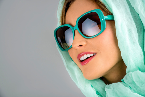 Fashion woman in sunglasses and wearing a headscarf