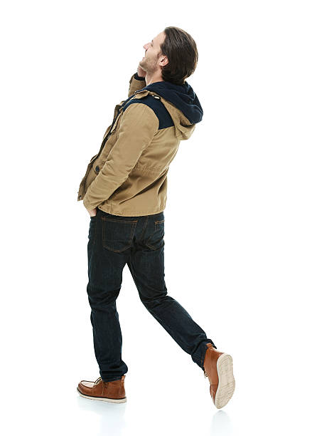 istock Rear view of casual man on mobile and walking 505534592