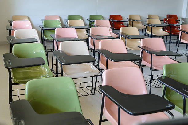 istock Many lecture chairs arranged neatly in empty classroom. 505535168