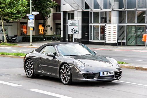 Berlin, Germany - September 12, 2013: Motor car Porsche 991 911 drives in the city street.