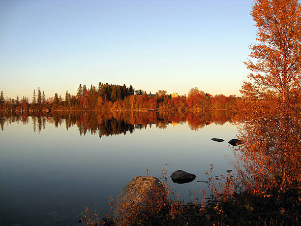 istock Red trees reflction in the mirror lake 505536693