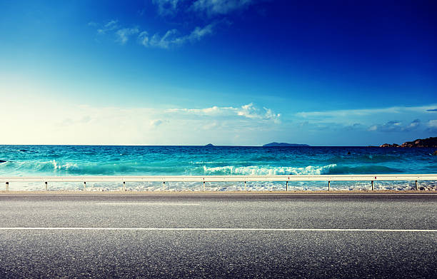 istock road and sea in sunset time 505536963