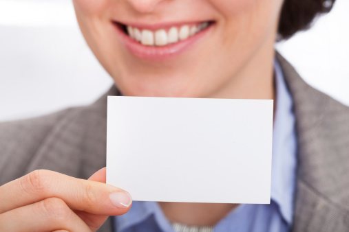 Portrait Of Smiling Businesswoman Showing Visiting Card