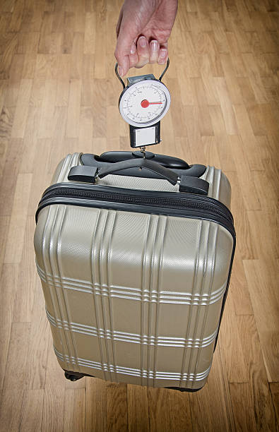istock Hand luggage measurement using steelyard balance. 505537325