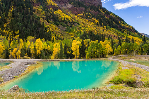 Tailings Ponds with Fall Aspens - Scenic landscape with turquoise aquamarine ponds from mining.  Telluride, Colorado USA.