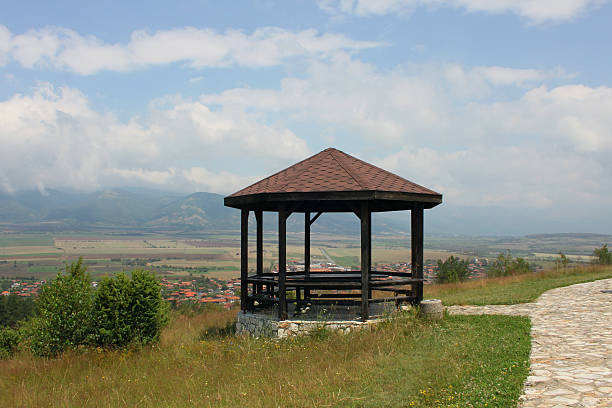 Wooden pavilion high above a small village