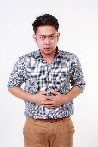 istock man with strong stomach pain 505546839