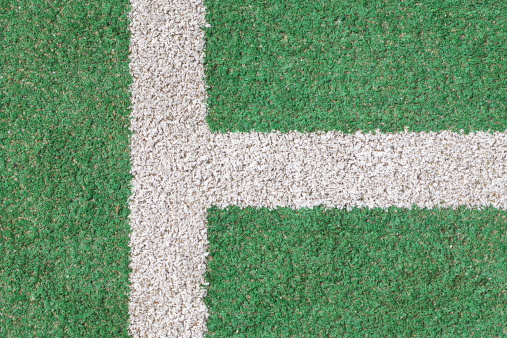 Green grass and White strip in the field for football