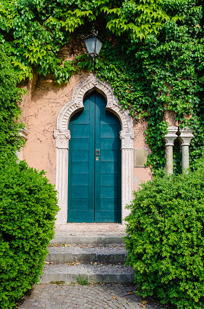 Beautiful gate to the garden surrounded with flowers