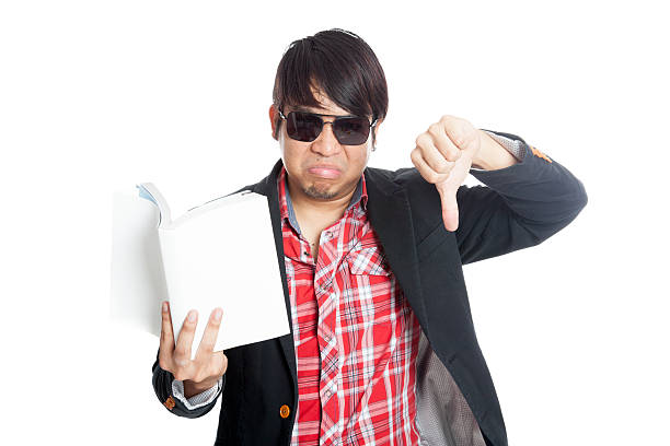 istock Asian man upset read a book show thumbs down 505549691