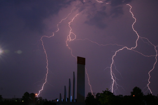 Lightning flashes dance across the purple sky during a July thunderstorm.