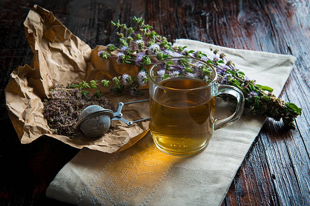 Mentha pulegium infusion Mentha pulegium infusion on a wooden table mentha pulegium stock pictures, royalty-free photos & images